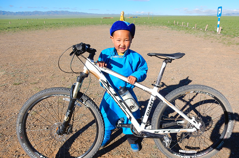 Mongolian kid with bicycle